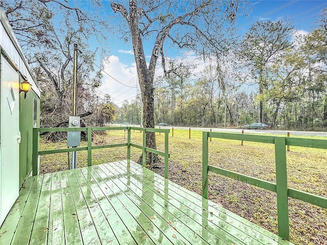 wooden deck with a lawn