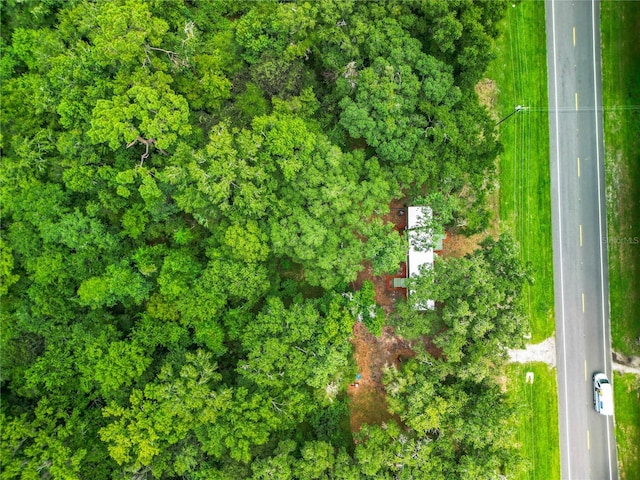 birds eye view of property featuring a wooded view