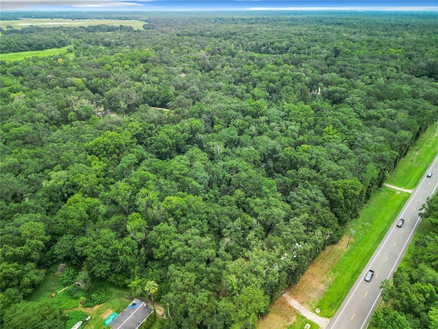 birds eye view of property with a view of trees