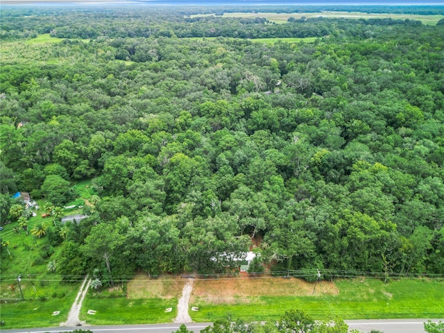 birds eye view of property featuring a view of trees