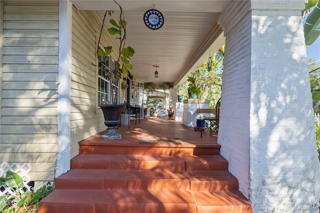 wooden terrace featuring covered porch