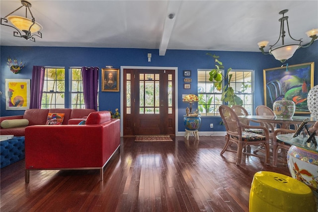 entryway featuring beam ceiling, dark wood-style flooring, a wealth of natural light, and baseboards