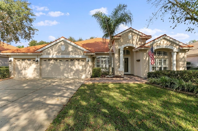 view of front facade featuring an attached garage, a tile roof, concrete driveway, stucco siding, and a front yard