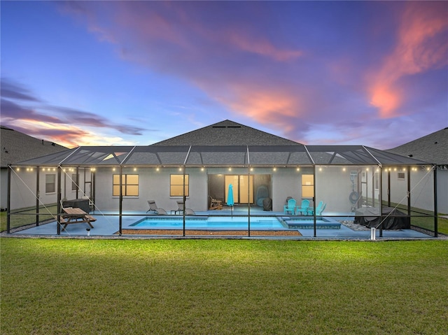 back of property at dusk featuring a lanai, a patio area, an outdoor pool, and a yard