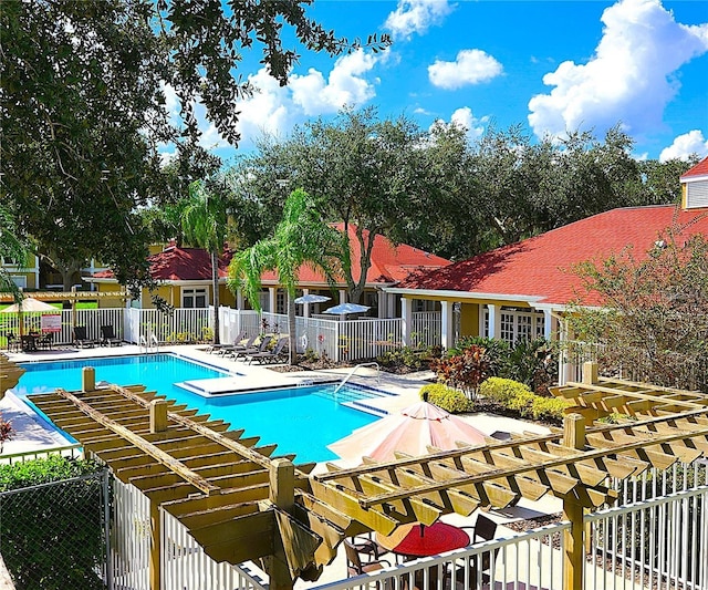 pool with a patio area, fence, and a pergola