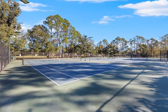 view of tennis court featuring fence