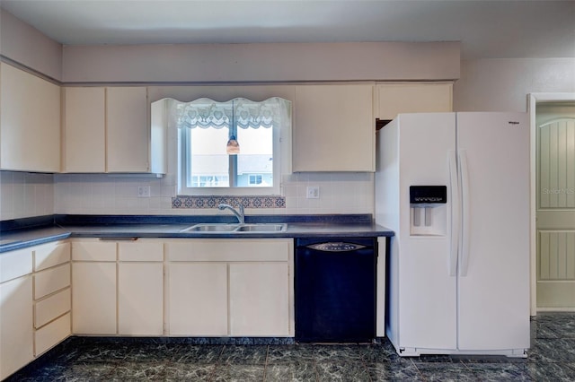 kitchen with tasteful backsplash, white refrigerator with ice dispenser, dishwasher, dark countertops, and a sink