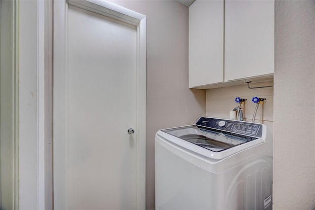 laundry area featuring washer / dryer and cabinet space