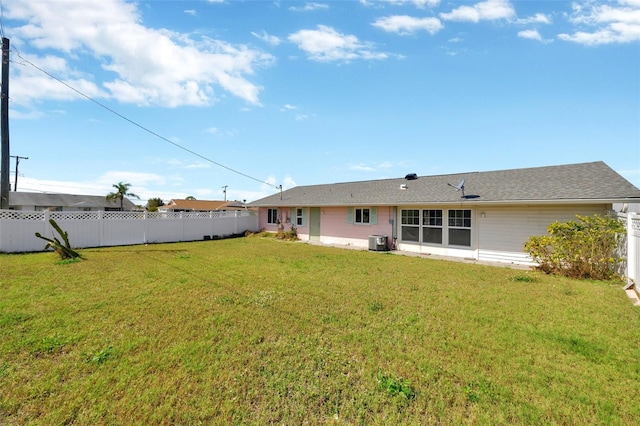 back of house featuring fence, cooling unit, and a yard