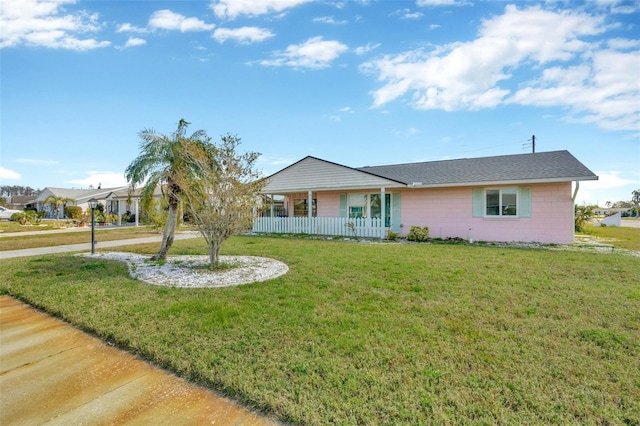 ranch-style home with a front lawn and a porch