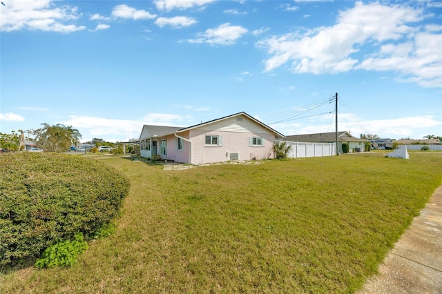 exterior space with a yard and fence