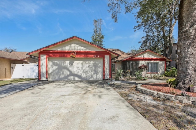 ranch-style house with concrete driveway and an attached garage