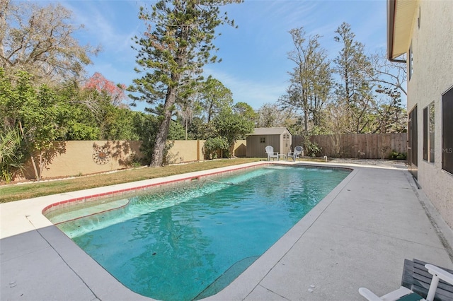 view of pool with a fenced backyard, a storage shed, an outdoor structure, a fenced in pool, and a patio area