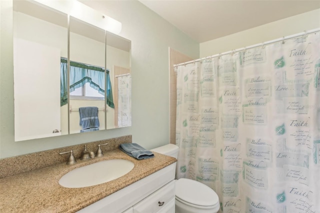 full bathroom featuring curtained shower, vanity, and toilet