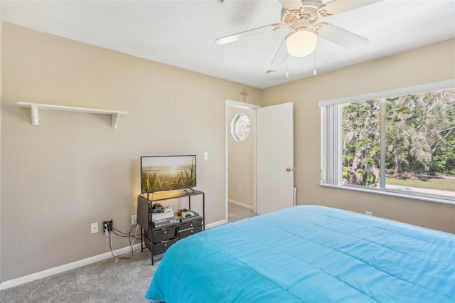 carpeted bedroom featuring ceiling fan and baseboards