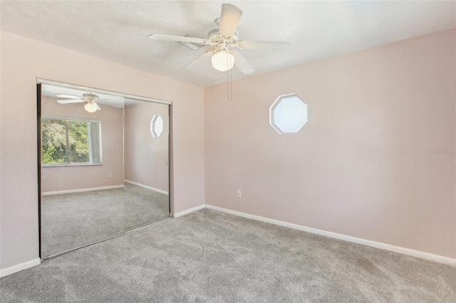 unfurnished bedroom with baseboards, a closet, and light colored carpet