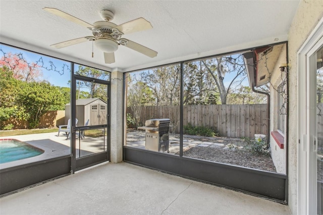 unfurnished sunroom with a ceiling fan