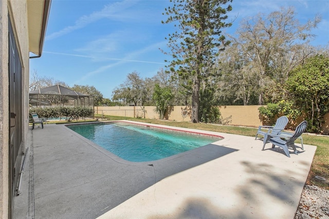 view of pool with a lanai, a patio area, a fenced backyard, and a fenced in pool