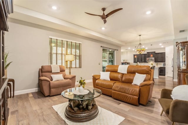 living room featuring recessed lighting, visible vents, and light wood-style floors