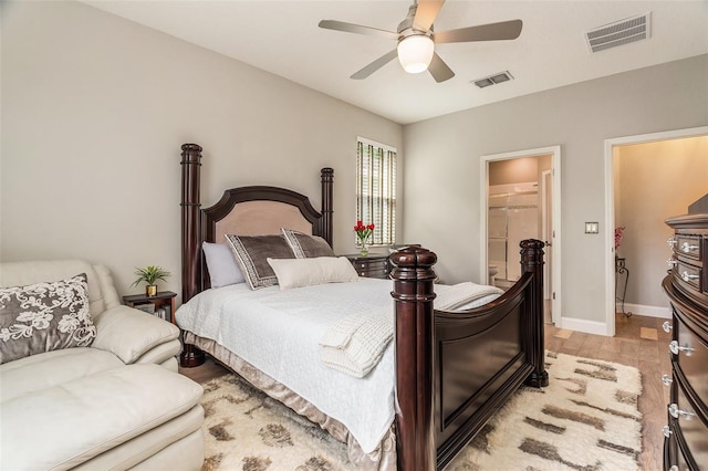 bedroom featuring light wood-type flooring, visible vents, baseboards, and ceiling fan