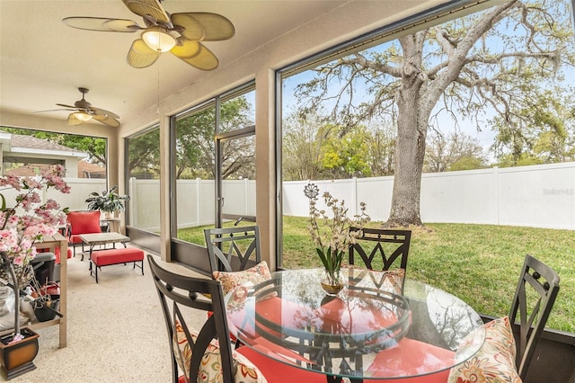 sunroom / solarium with a ceiling fan