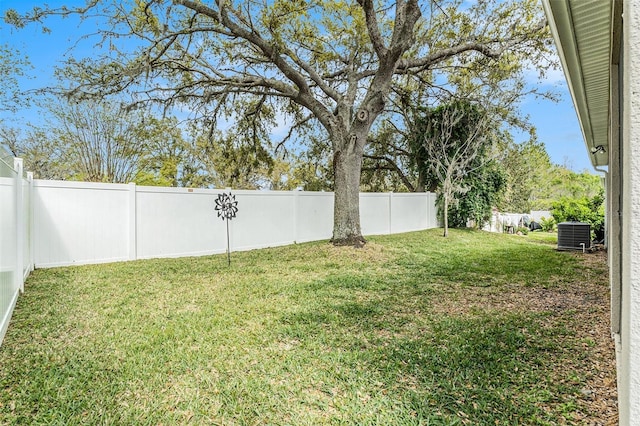 view of yard with central air condition unit and a fenced backyard