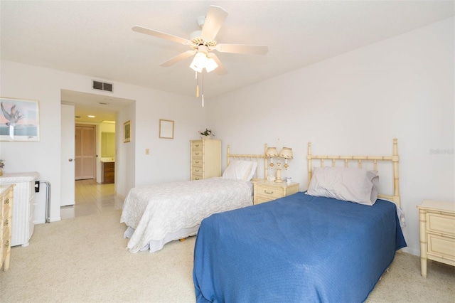 bedroom featuring visible vents, a ceiling fan, and light colored carpet