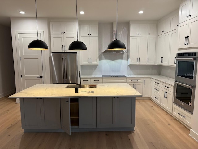 418 W Frances Ave Unit 2, Tampa, FL 33602 - kitchen featuring appliances with stainless steel finishes, a sink, light wood-style flooring, a center island with sink, and recessed lighting