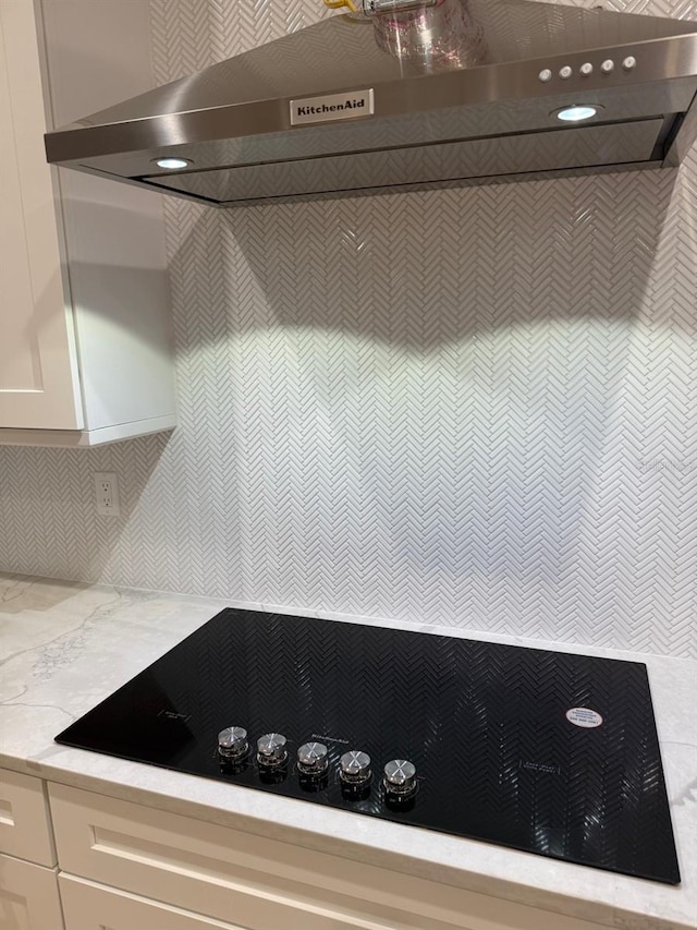 418 W Frances Ave Unit 2, Tampa, FL 33602 - kitchen view of under cabinet range hood, black electric cooktop, white cabinets, and light stone counters