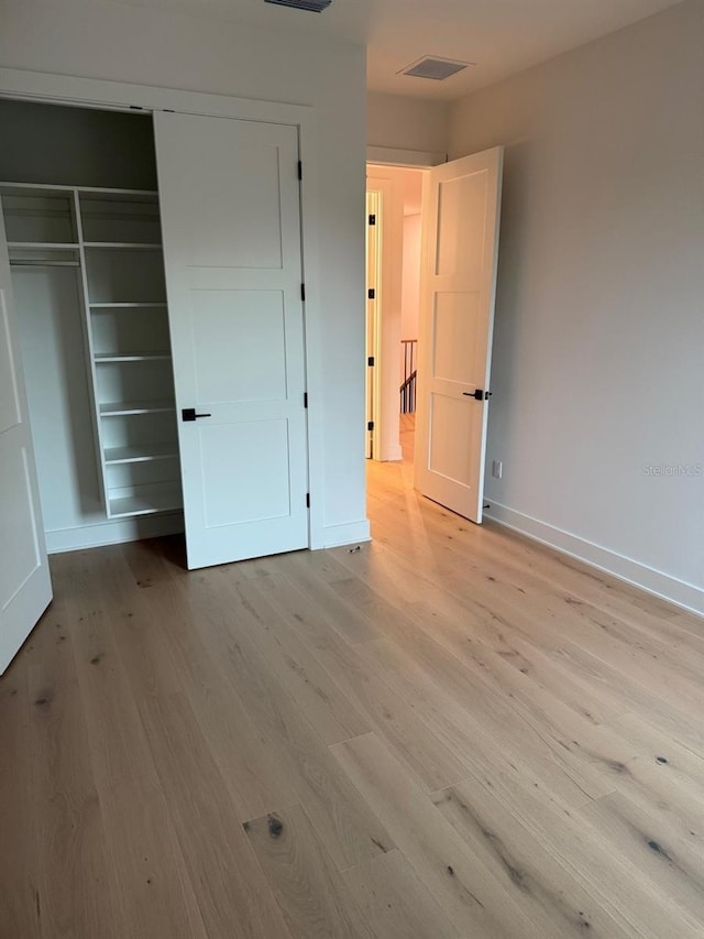 418 W Frances Ave Unit 2, Tampa, FL 33602 - unfurnished bedroom with light wood-style floors, a closet, and baseboards