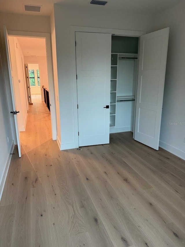418 W Frances Ave Unit 2, Tampa, FL 33602 - unfurnished bedroom featuring light wood-style flooring, a closet, and baseboards