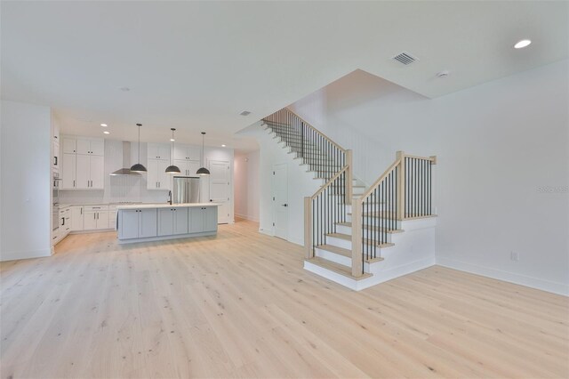 418 W Frances Ave Unit 2, Tampa, FL 33602 - unfurnished living room featuring light wood-type flooring, baseboards, and recessed lighting