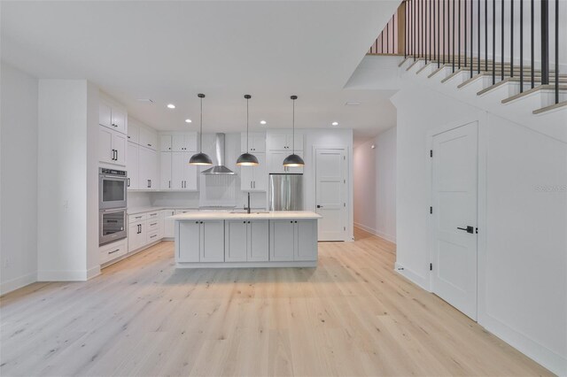 418 W Frances Ave Unit 2, Tampa, FL 33602 - kitchen featuring stainless steel appliances, wall chimney exhaust hood, a sink, baseboards, and recessed lighting