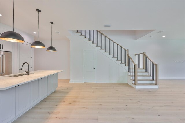 418 W Frances Ave Unit 2, Tampa, FL 33602 - bar with a sink, stairs, light wood-style flooring, baseboards, and recessed lighting