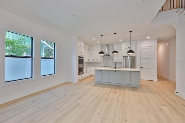 418 W Frances Ave Unit 2, Tampa, FL 33602 - kitchen featuring appliances with stainless steel finishes, wall chimney range hood, baseboards, light wood-style floors, and recessed lighting