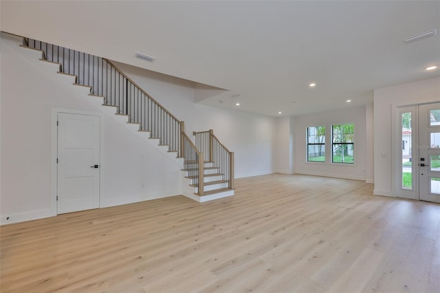 418 W Frances Ave Unit 2, Tampa, FL 33602 - unfurnished living room with light wood finished floors, stairway, recessed lighting, and baseboards