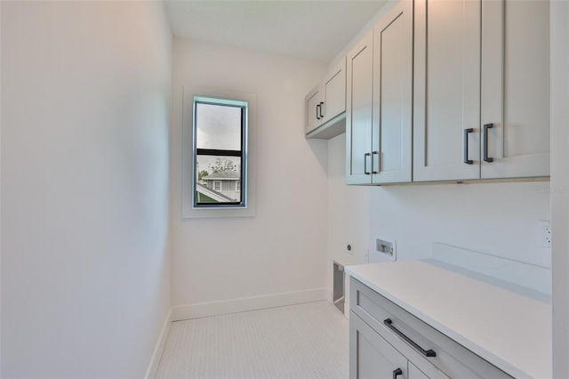 418 W Frances Ave Unit 2, Tampa, FL 33602 - laundry room featuring cabinet space, electric dryer hookup, baseboards, washer hookup, and light tile patterned floors
