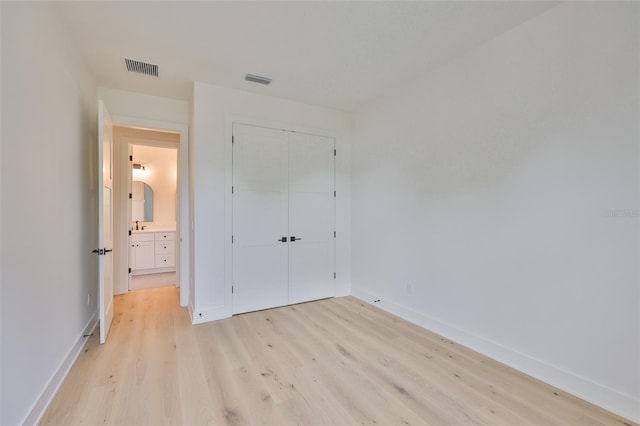 418 W Frances Ave Unit 2, Tampa, FL 33602 - unfurnished bedroom featuring light wood-type flooring, baseboards, and a closet