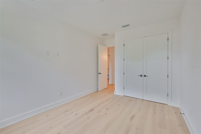 418 W Frances Ave Unit 2, Tampa, FL 33602 - unfurnished bedroom featuring light wood-style floors, baseboards, and a closet