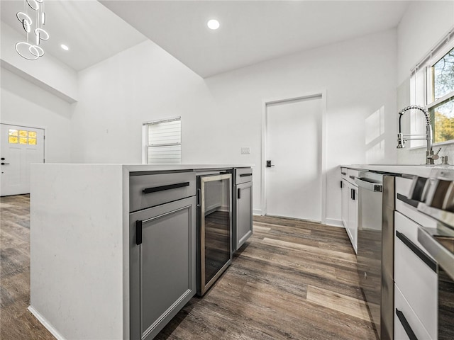 kitchen featuring dark wood finished floors, wine cooler, dishwasher, recessed lighting, and gray cabinets