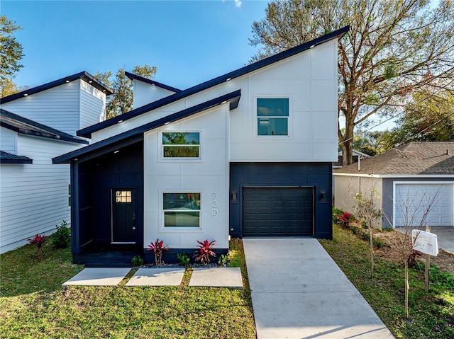 contemporary house featuring a garage, driveway, and stucco siding