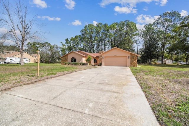 view of front facade featuring concrete driveway, a front lawn, an attached garage, and stucco siding