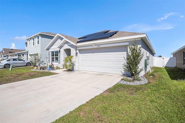 ranch-style home featuring a garage, solar panels, driveway, stucco siding, and a front lawn