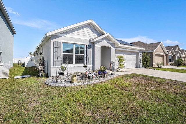 view of front of home with an attached garage, driveway, fence, and a front yard