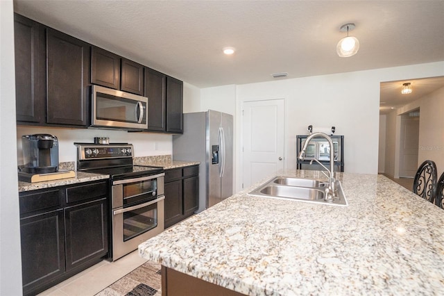 kitchen with stainless steel appliances, light countertops, a sink, and visible vents