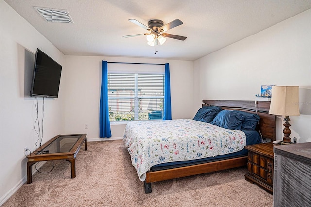 bedroom featuring light carpet, baseboards, visible vents, ceiling fan, and a textured ceiling