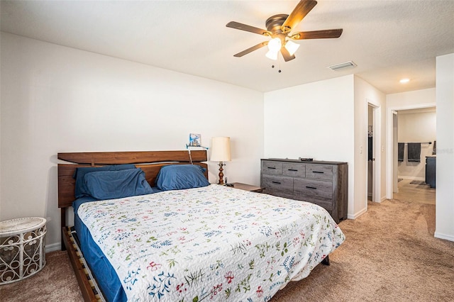 carpeted bedroom with a ceiling fan, visible vents, and baseboards