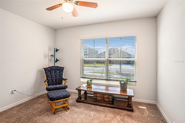 sitting room with ceiling fan, baseboards, and carpet flooring