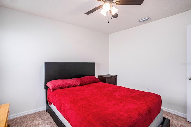 carpeted bedroom featuring baseboards, visible vents, and ceiling fan