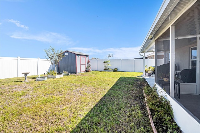 view of yard featuring an outbuilding, a fenced backyard, a sunroom, a garden, and a shed